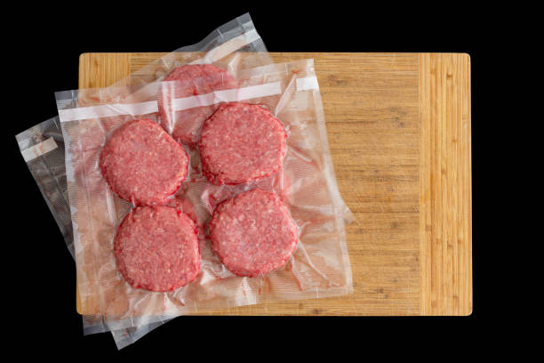 Isolated beef burger patties prepared for freezing stock photo