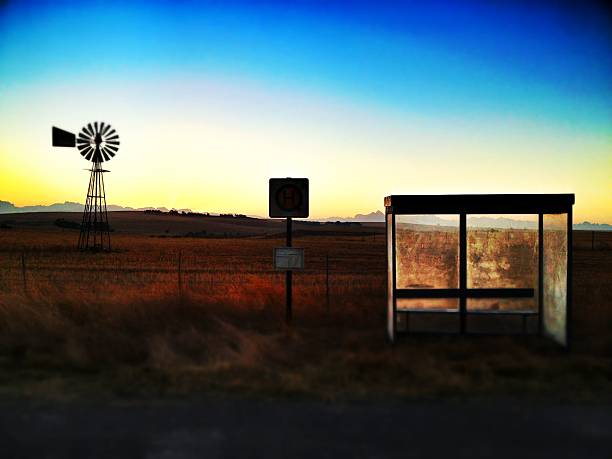 Isolated Bus Stop with Windmill in Background. stock photo