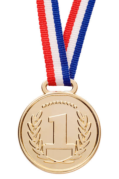 Isolated gold medal with ribbon A gold medal, isolated on white. gold medal stock pictures, royalty-free photos & images