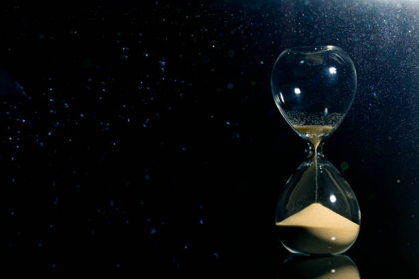 Isolated hourglass in the dark stock photo