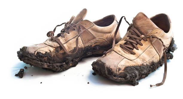 isolated muddy footwear shoes - muddy shoes stockfoto's en -beelden