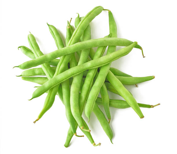 Isolated pile of green beans Isolated beans. Pile of raw green beans (haricot), top view, isolated on white background green bean stock pictures, royalty-free photos & images