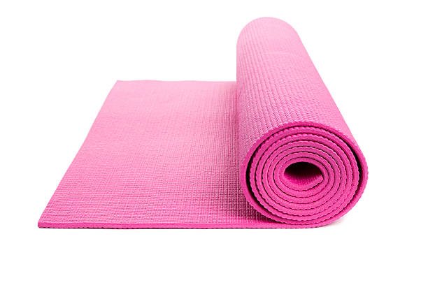 Isolated pink yoga mat, slightly unrolled stock photo