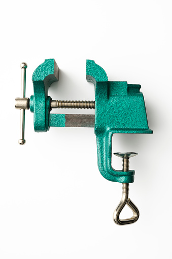 Overhead shot of opend green table vice isolated on white with clipping path.