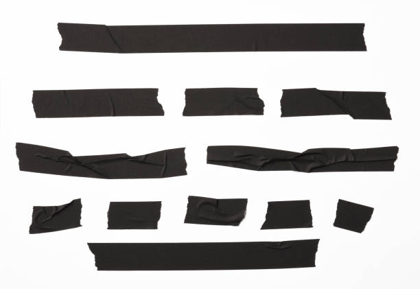 Isolated shot of torn black adhesive tape on white background Many torn black adhesive tape, isolated on white with clipping path. adhesive tape stock pictures, royalty-free photos & images