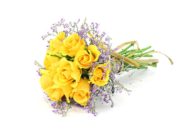 Isolated yellow rose bouquet , mauve foliage with a paper bow stock photo