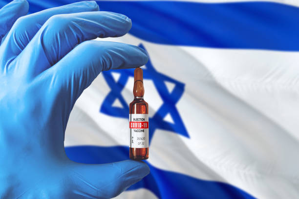 israel flag with coronavirus covid-19 concept. doctor with blue protection medical gloves holding a vaccine bottle. epidemic virus, cov-19, corona virus outbreaking. - israel imagens e fotografias de stock