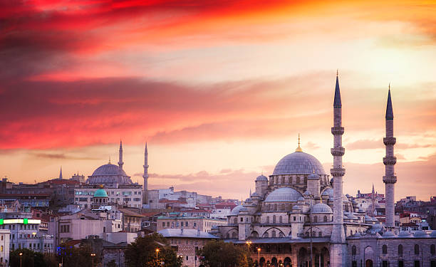 Istanbul skyline at sunset with dramatic sky Istanbul skyline at sunset with dramatic sky, featuring two mosques in the foreground. blue mosque stock pictures, royalty-free photos & images