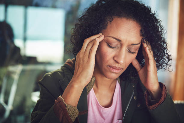 It hurts so bad Shot of a mature woman experiencing a headache cramp photos stock pictures, royalty-free photos & images