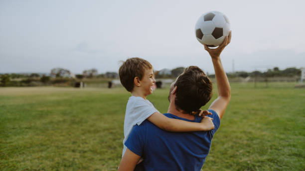 It is time for soccer Photo of father and son on a soccer court fathers day stock pictures, royalty-free photos & images