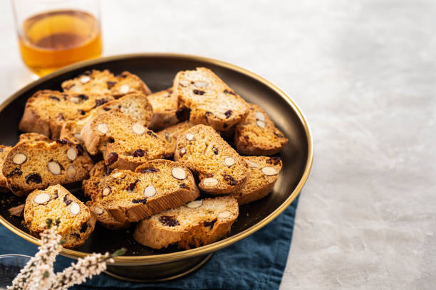 Italian almond biscotti biscuits and sweet wine in a glass on the table. Copy space. stock photo