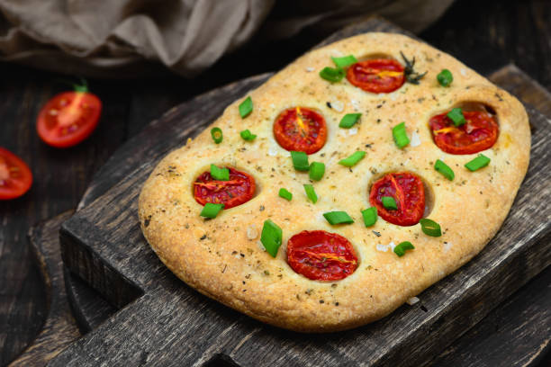 Italian focaccia with tomatoes top view stock photo
