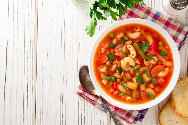 Italian minestrone soup on white wooden background. stock photo