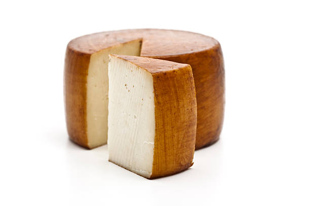 Italian pecorino cheese wheel with wedge removed stock photo