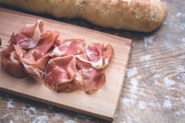 Italian prosciutto and baguette Italian prosciutto and fresh baguette prosciutto stock pictures, royalty-free photos & images