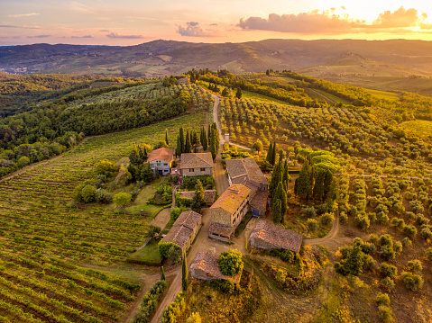 Tuscan small village in sunset from drone