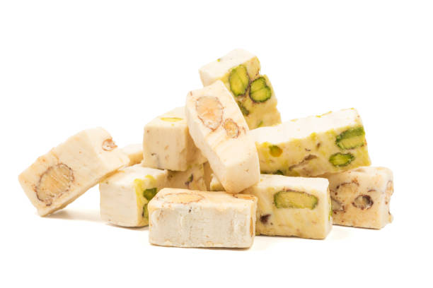 Italian torrone nougat candy blocks with almonds and pistachios isolated stock photo