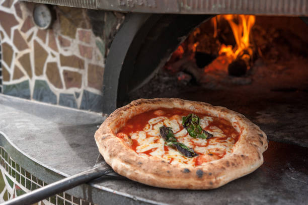 italiaanse traditionele pizza margherita gebakken in het hout gestookte oven - napoli stockfoto's en -beelden