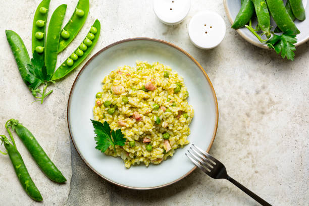 Italian, Venetian rice and spring green pea. Risi e bisi.  Spring dish made with Vialone nano rice, green peas, parsley and bacon. Ingredients. Horizontal image, copy space. stock photo
