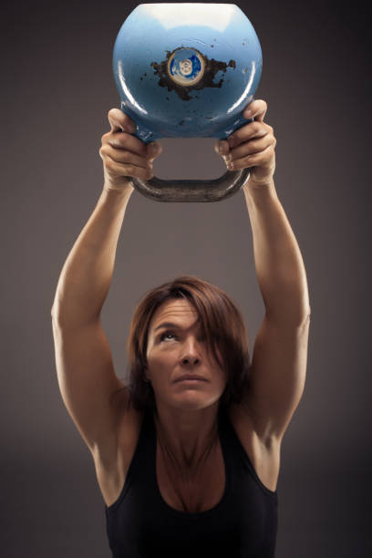 Italian Woman Raising a Kettle Bell stock photo