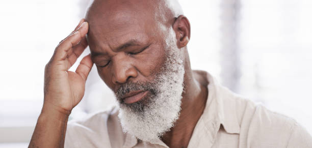 It's just one problem after the next Shot of a mature man suffering with a headache sad old black man stock pictures, royalty-free photos & images