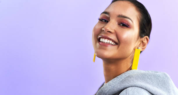 It’s not wear you wear it’s how you wear it Studio shot of a beautiful young woman posing against a purple background beautiful latina woman stock pictures, royalty-free photos & images