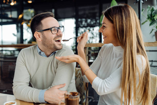 It's really tasty Girl feeding her boyfriend. Hot chocolate. couple eating chocolate stock pictures, royalty-free photos & images
