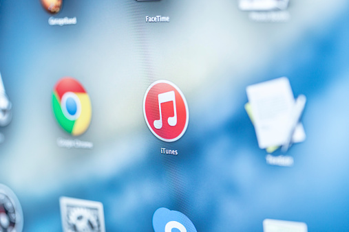 Moscow, Russia - December 20, 2014: Close-up of the iTunes application icon on the screen. iTunes is an application that allows users to purchase, download and listen to music and video via computers or other iTunes compatible devices.