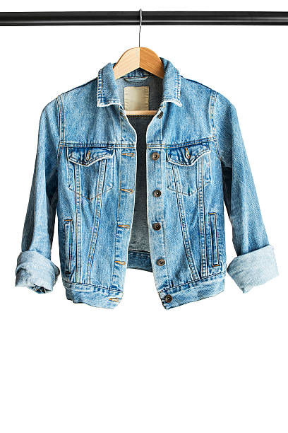 Jacket on clothes rack Blue denim jacket hanging on clothes rack isolated over white jacket stock pictures, royalty-free photos & images