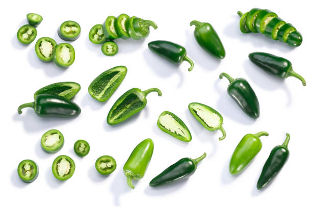Jalapeno chiles whole sliced chopped, top, paths Jalapeno chile pepper (Capsicum annuum fruits), whole, chopped, halved, and sliced pods, top view, isolated chopped food stock pictures, royalty-free photos & images