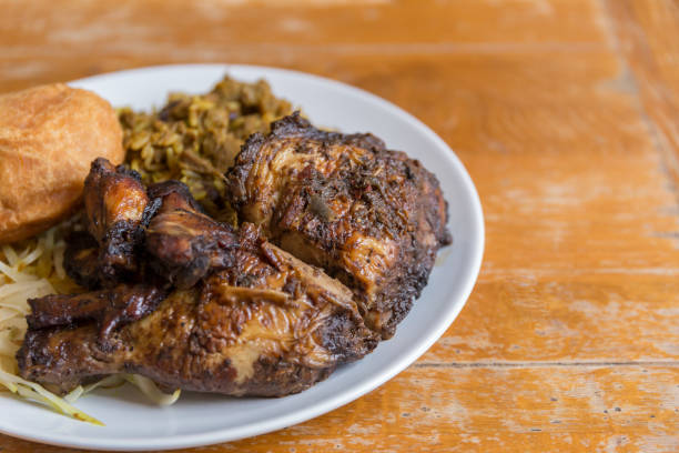 Jamaican curry goat, jerk chicken and fried dumpling stock photo