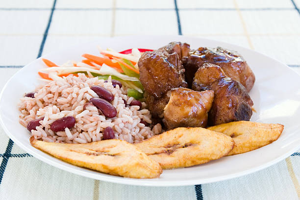 Jamaican style chicken with rice and beans and vegetables stock photo