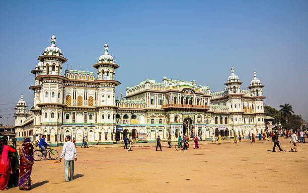 Janaki Mandir Janakpur, Nepal - March 19, 2014: Janaki Mandir, Janakpur, India, was buildt in 1911 AD, and is considered as the most important example of the Rajput architecture in Nepal. It is dedicated to goddess Sita. Nepali people are walking around on the big plaza in front of the temple. They are dressed in their best clothings, the women wear beautiful colorful sarees. terai stock pictures, royalty-free photos & images