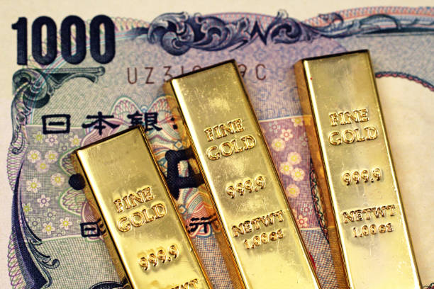 Japanese 1000 yen note with three small gold bars in macro stock photo