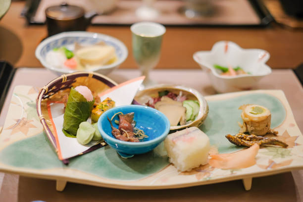 山梨県川口湖の伝統的旅館リゾートの木製テーブルに日本の夕食セットと前菜 - 宿屋 ストックフォトと画像