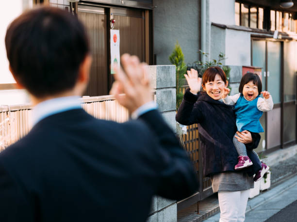Japanese Family Life A typical Japanese family going about their daily life in Tokyo, Japan. wave goodbye asian stock pictures, royalty-free photos & images