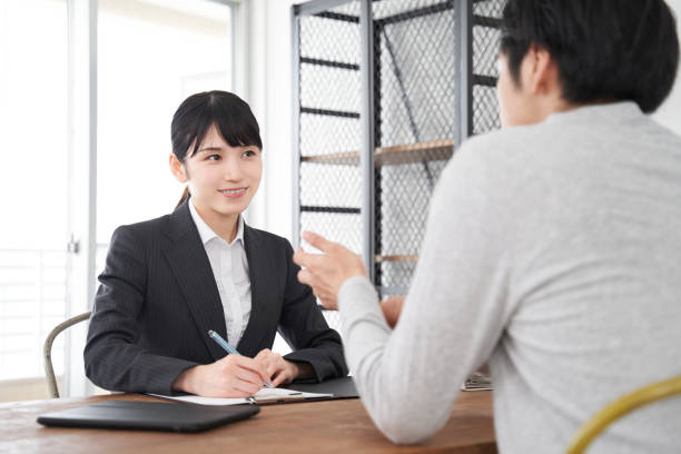 依頼を聞く日本人女性不動産販売員 - インタビュー　日本人 ストックフォトと画像