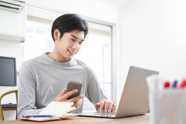 Japanese male businessman working from home in plain clothes Japanese male businessman working from home in plain clothes japanese ethnicity stock pictures, royalty-free photos & images