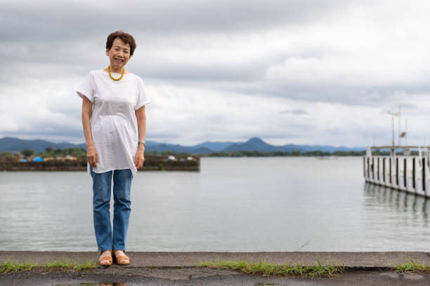 Japanese senior woman enjoying water view stock photo