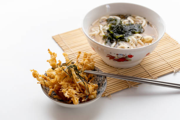 Japanese Style Deep Fried Crispy Enokitake Mushroom And Udon noodles Japanese Kake udon noodles in a bowl on white background. Vegetarian food. enoki mushroom stock pictures, royalty-free photos & images