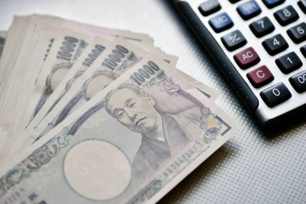 Japanese Ten Thousand Yen Bills And Calculator Japanese Ten Thousand Yen Bills And Calculator BANK OF JAPAN   stock pictures, royalty-free photos & images