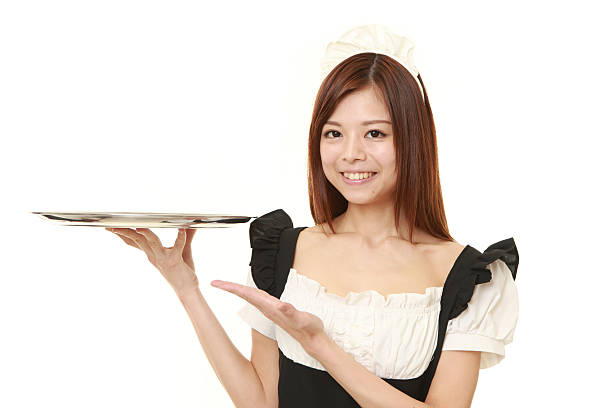 Japanese woman wearing french maid costume presenting and showing something portrait of young Japanese woman wearing french maid costume french maid outfit stock pictures, royalty-free photos & images
