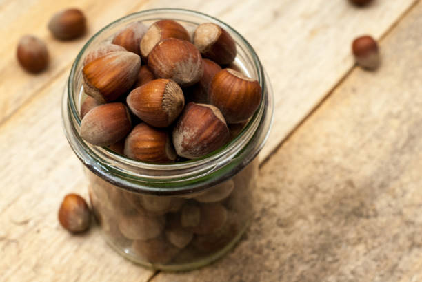 Jar of hazelnuts stock photo