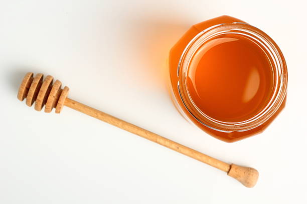 Jar of Honey with Honey Dipper stock photo