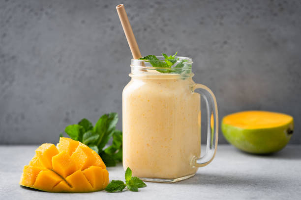 Jar of mango lassi Jar of mango lassi or mango yogurt smoothie. Healthy tropical fruit smoothie mango smoothie stock pictures, royalty-free photos & images