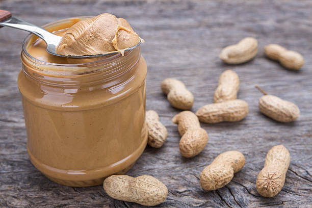 Jar of peanut butter with nuts. stock photo