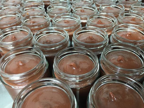 Jars of chocolate carob spread in factory stock photo