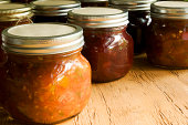 Homemade preserves of salsa and cranberry jam.