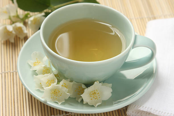 Jasmine tea and flowers stock photo