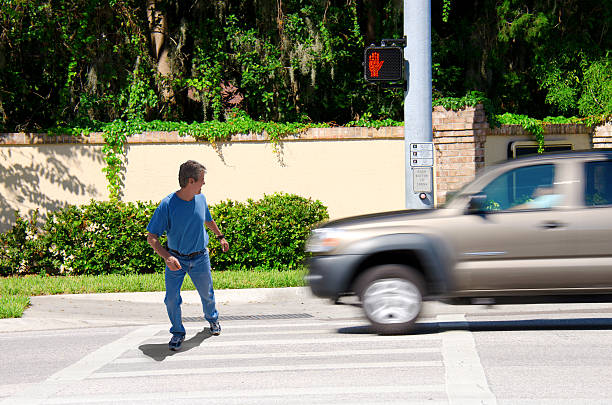 Jaywalking man about to be run over by truck stock photo